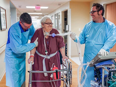 Patient on a pulmonary ventilator being treated by a therapist